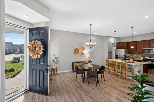 Step into a bright, open-concept main level featuring attractive flooring, neutral finishes, and an easy flow between the kitchen, dining, and living spaces.
