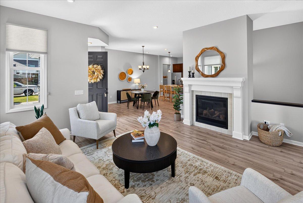 Open and inviting living area featuring a beautiful gas fireplace, abundant natural light, and a seamless connection to the dining area.