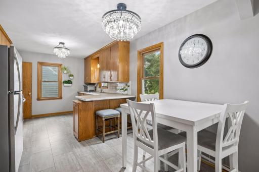 The eat-in kitchen has been updated with designer lighting and new flooring.