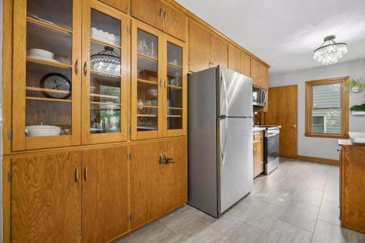 You'll enjoy extensive cabinetry, including these charming glass-front display cases.