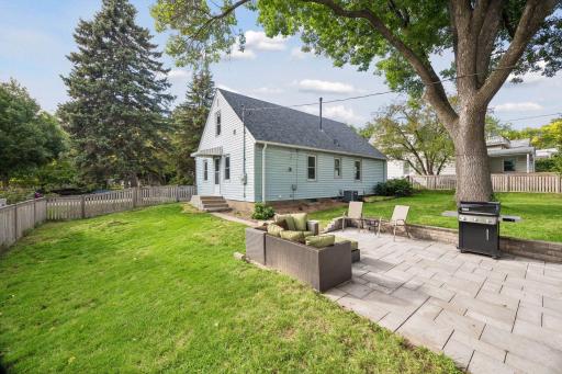 The fully fenced backyard features a new paver patio - perfect for relaxing or enjoying the outdoors.