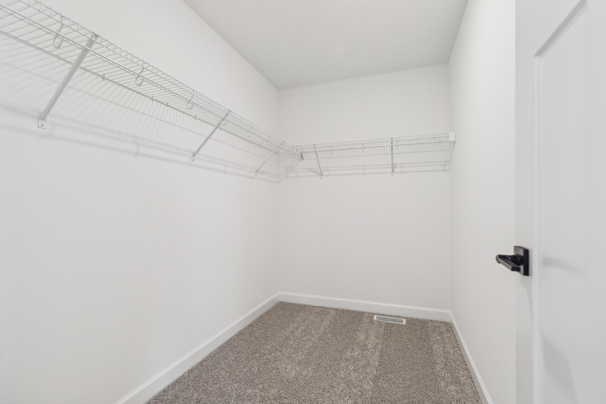 Thoughtfully designed primary closet offering convenient functionality and plenty of space to simplify everyday chores. *Photo of Actual Home