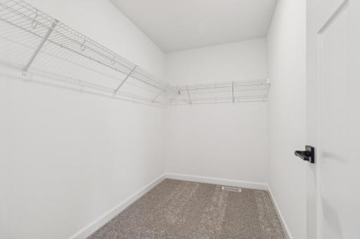 Thoughtfully designed primary closet offering convenient functionality and plenty of space to simplify everyday chores. *Photo of Actual Home