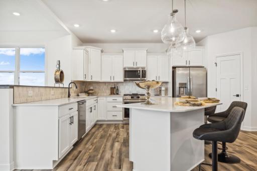 Beautifully designed kitchen featuring a spacious center island, modern finishes, and ample cabinetry for both everyday living and entertaining! *Photo of Actual Home