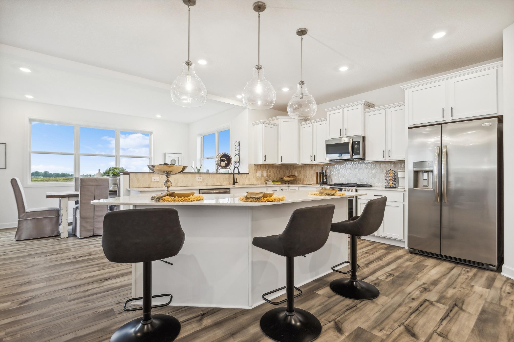 Modern kitchen featuring a large island, plenty of prep space, and an open-concept design that keeps you connected to the main living areas. *Photo of Actual Home