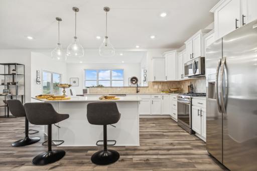 Stylish and functional kitchen featuring modern finishes, generous cabinetry, and a spacious island perfect for gathering. *Photo of Actual Home