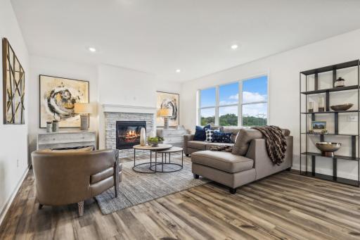 Bright and inviting living room featuring an open layout, comfortable living space, and plenty of natural light! *Photo of Actual Home