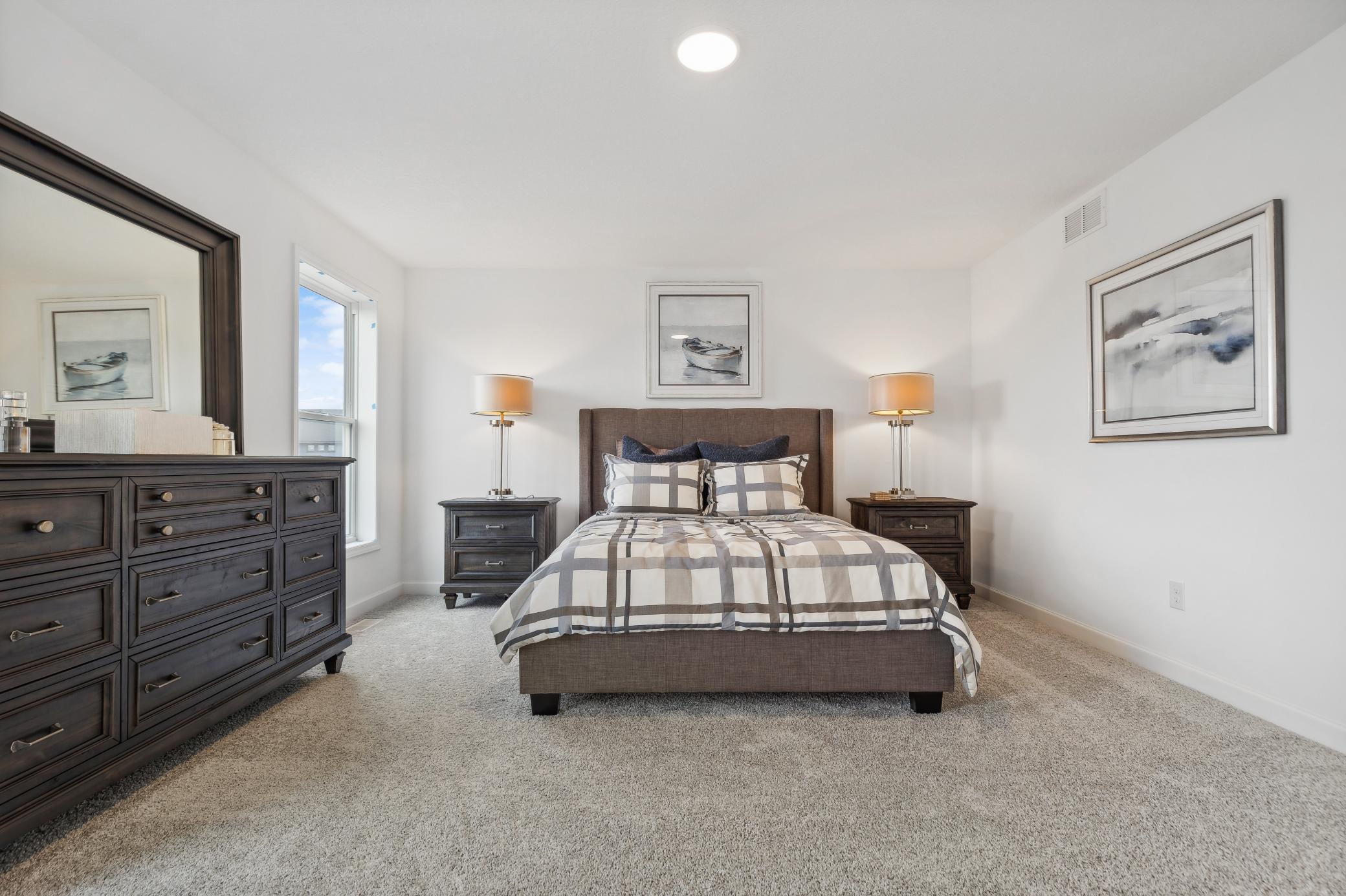 Spacious primary bedroom designed as a relaxing retreat, offering plenty of room for comfortable furnishings and personal touches! *Photo of Actual Home