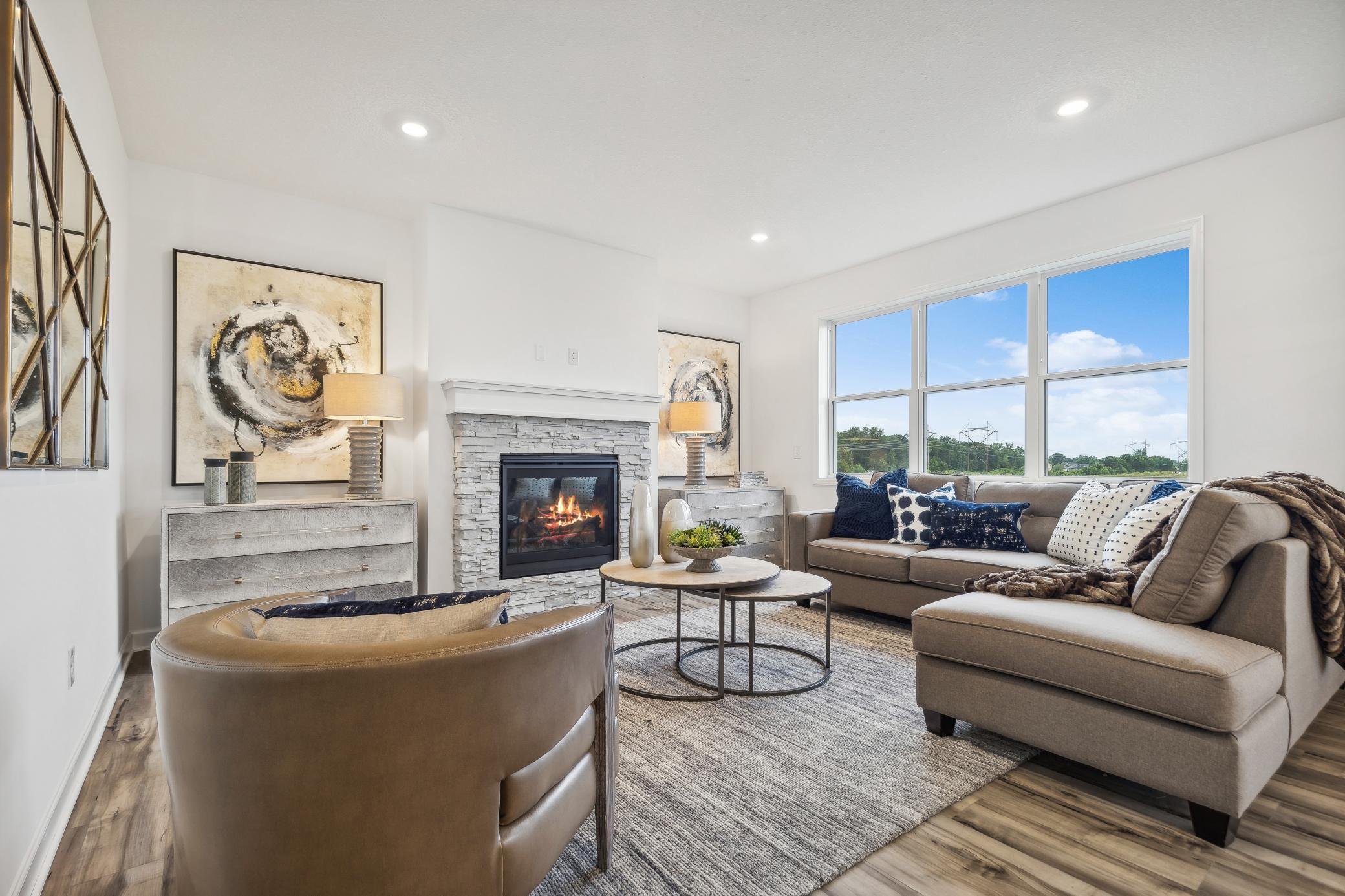 Light-filled living room creates an inviting gathering space with a spacious layout and easy flow throughout the main level. *Photo of Actual Home
