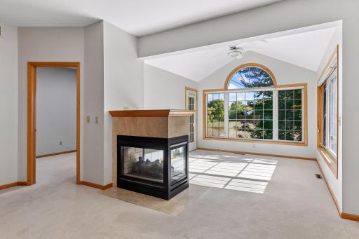 You'll love this 2 sided gas fireplace separating the living room and sunroom