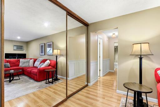 Large storage closet and more wainscotting in hallway