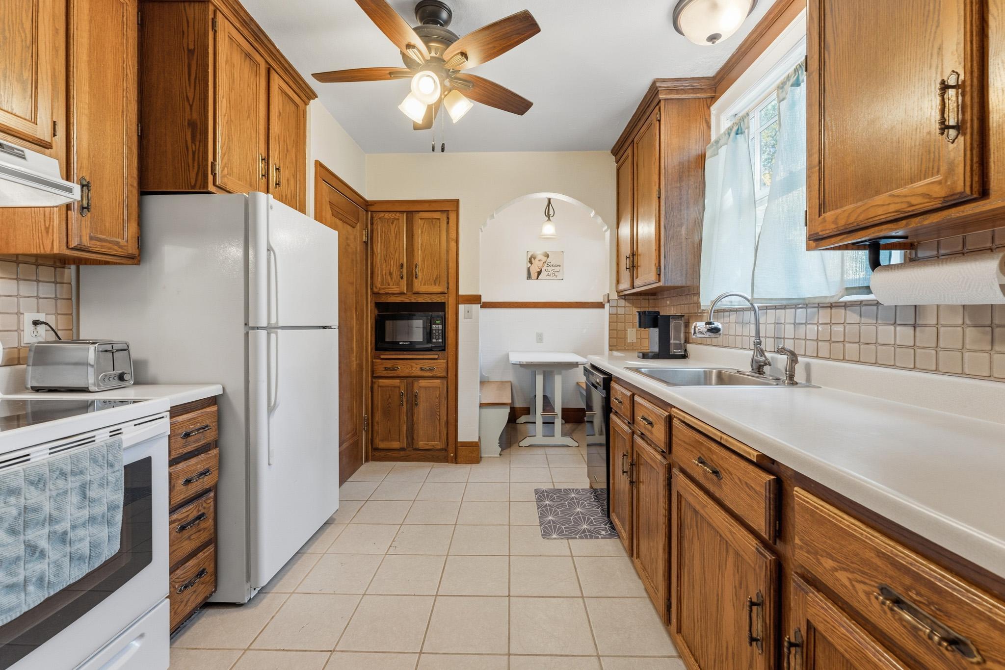 Full height cabinets offer ample counter space. The breakfast nook adds whimsy and a great place to chat.