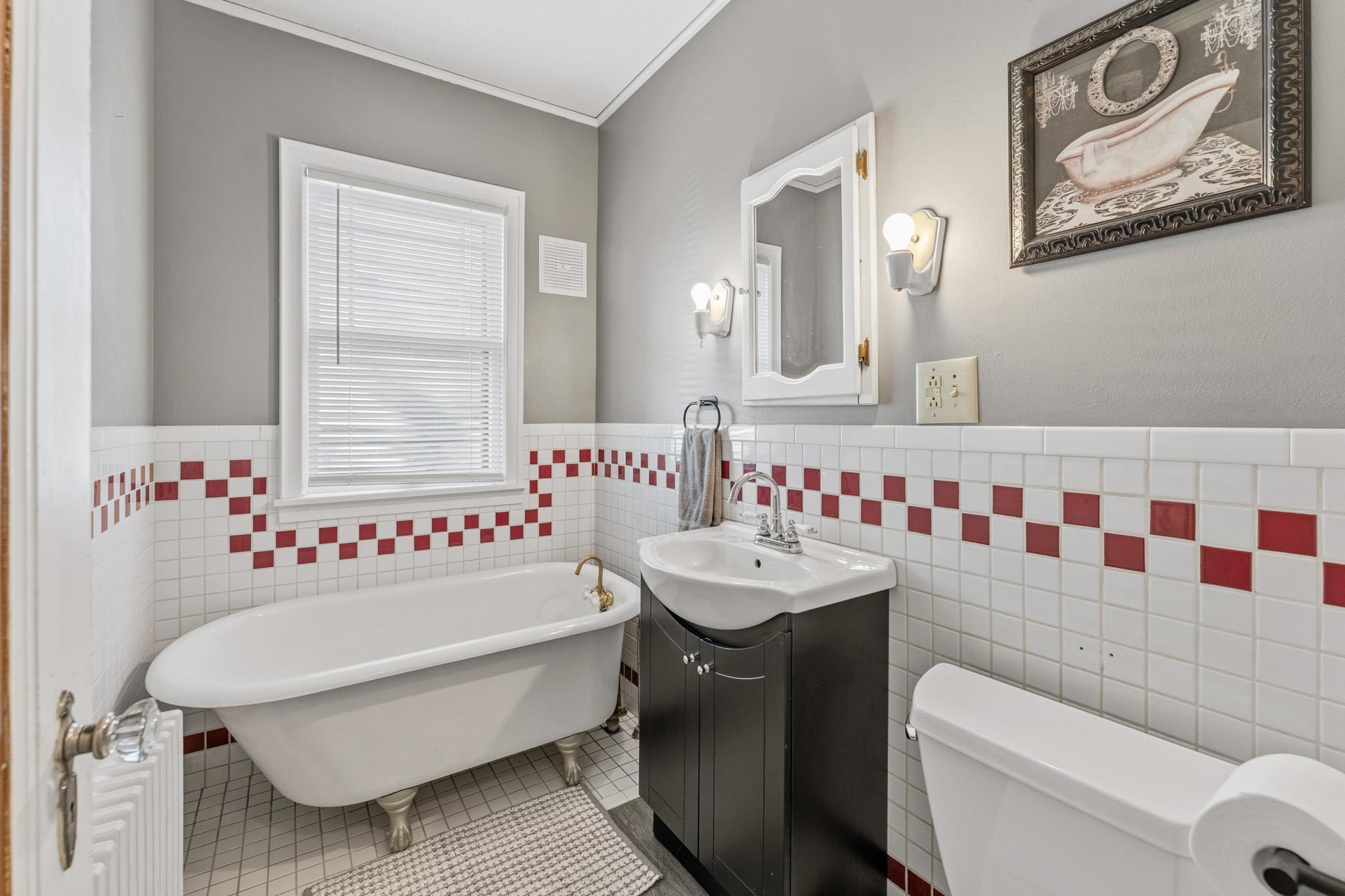 Main floor bath is full of character with claw-foot tub (tub spigot being replaced)