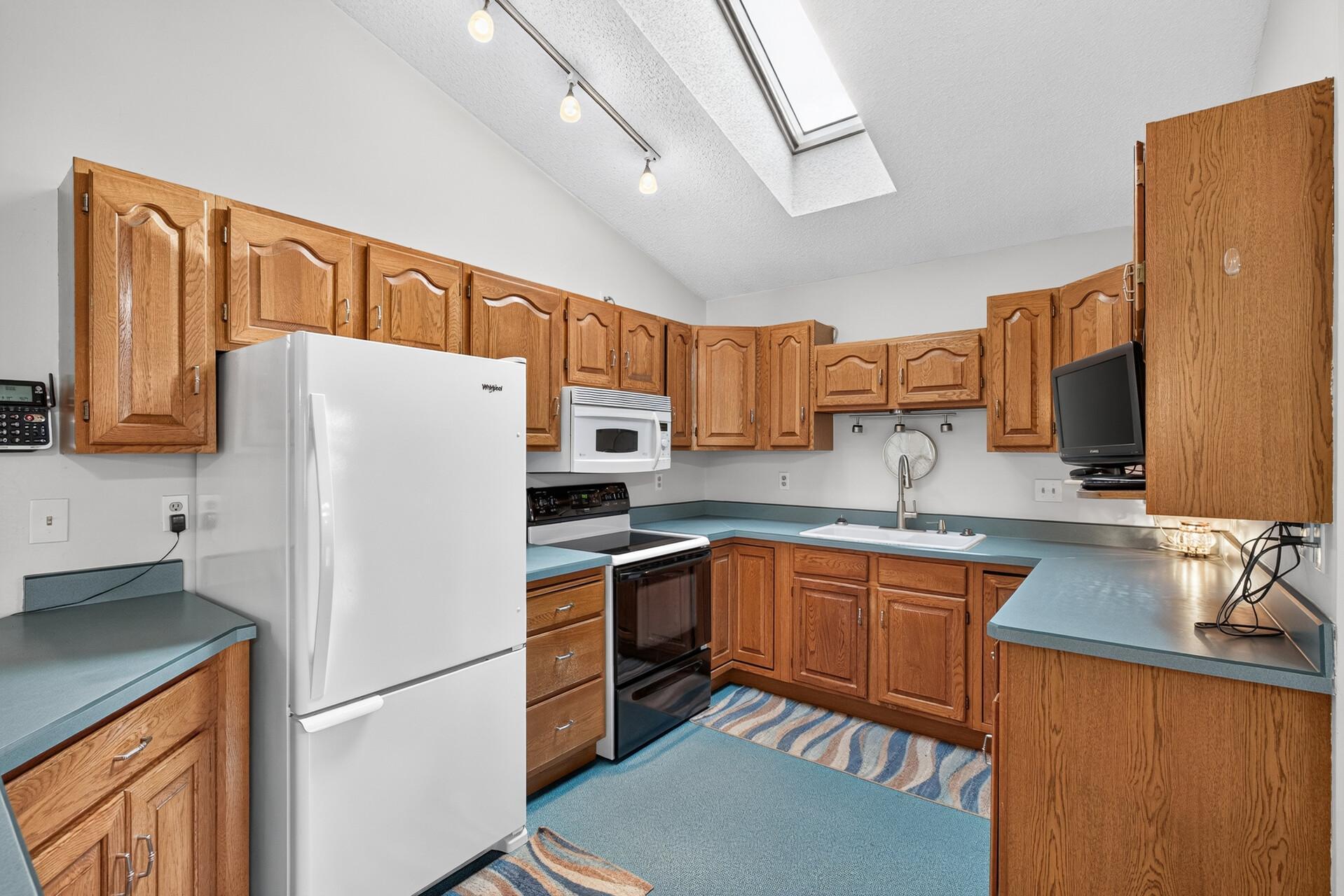 Flooring & cabinet updates do wonders! Lots of nice cabinets and good working space.