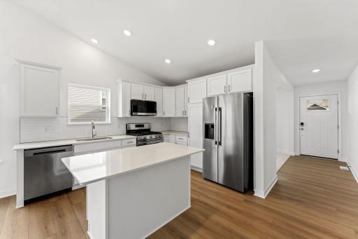 The chef-inspired kitchen showcases an elevated design, equipped with new cutting-edge appliances and a center island that adds bar-style seating.