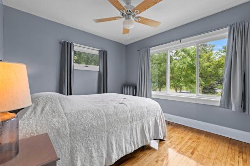 Main-level bedroom with refinished hardwood flooring.