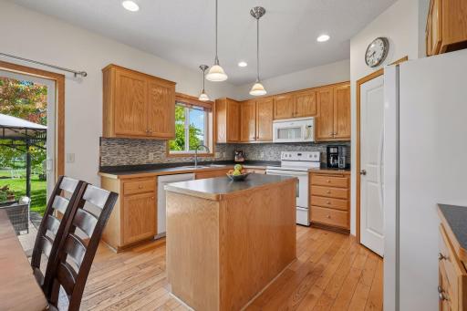 Kitchen with center island and tile backsplash