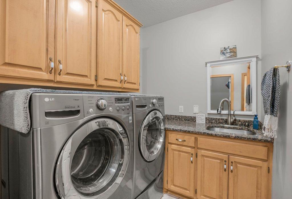 1 of 2 laundry rooms! Tons of storage and a sink!
