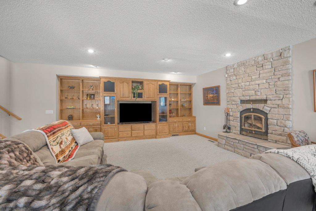 Family room has a stunning floor to ceiling fireplace and built-ins.
