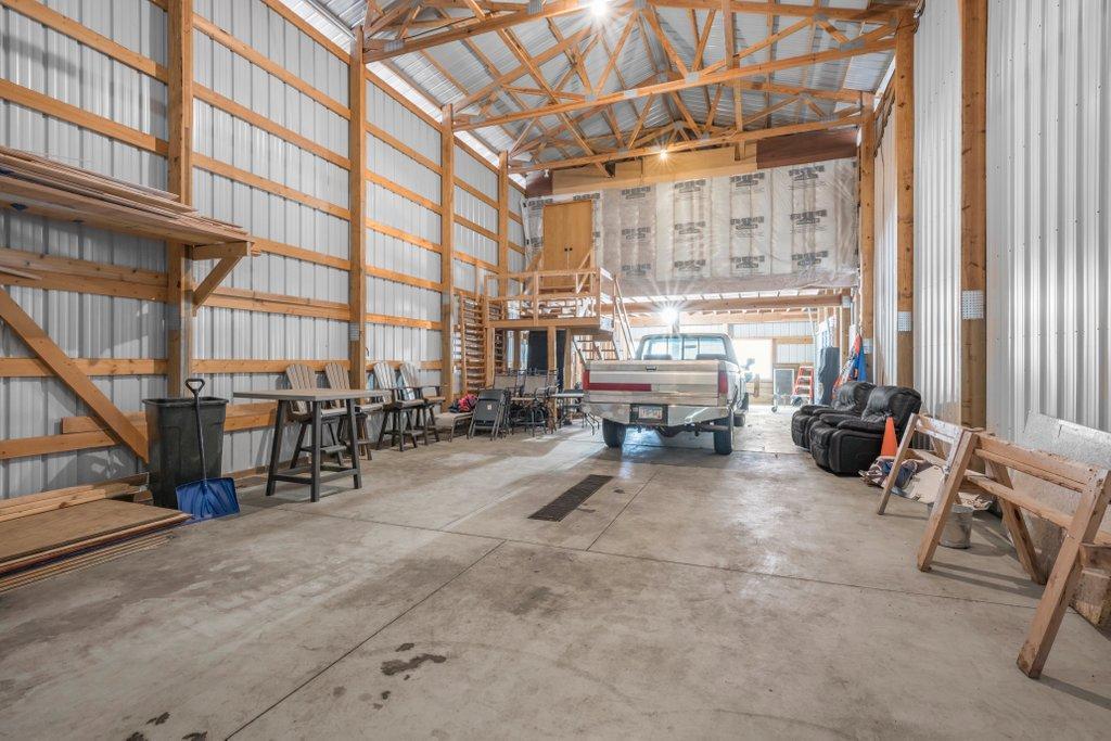Inside the detached building. There is heat in the 38x35 shop, no AC, electric throughout all 3 shops, and rough plumbing for bathroom under loft.