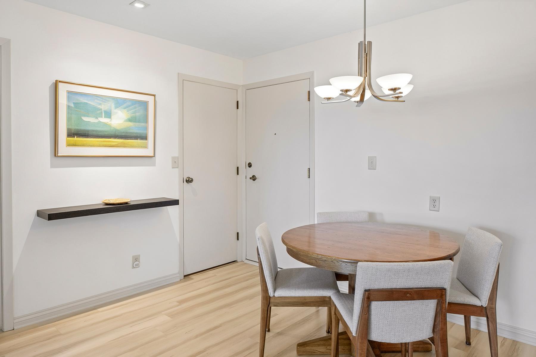 Entry door to the right, laundry room to the left. Sleek, minimalist shelving for key drop-off upon entry.