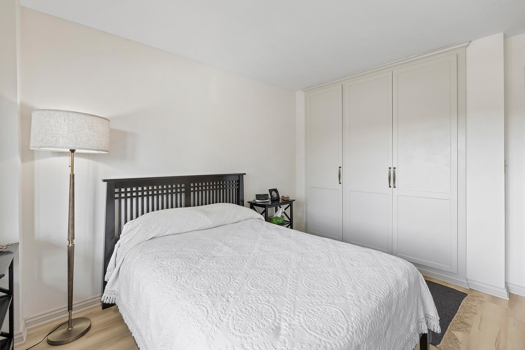 Attractive storage solution in the bedroom — floor-to-ceiling closet with paneled doors.