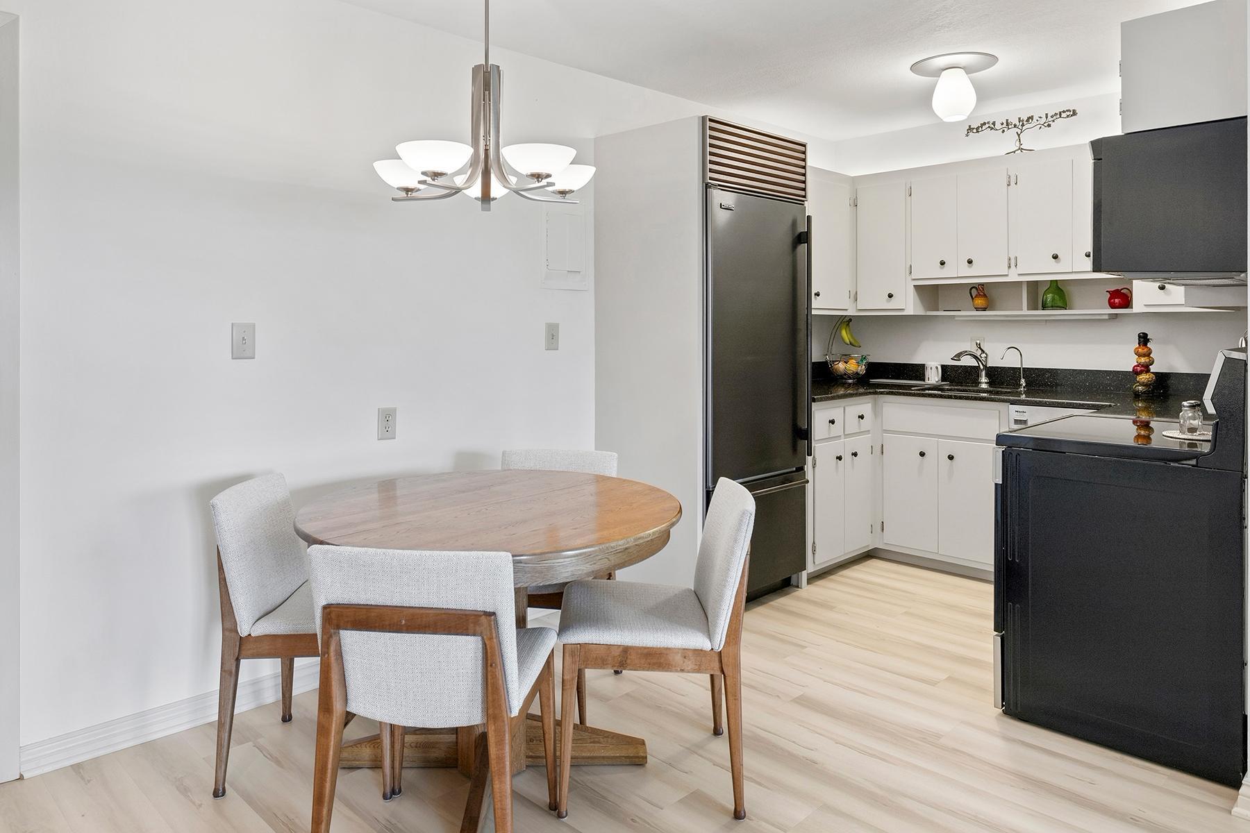 Informal dining off the kitchen. New flooring throughout ties it all together.