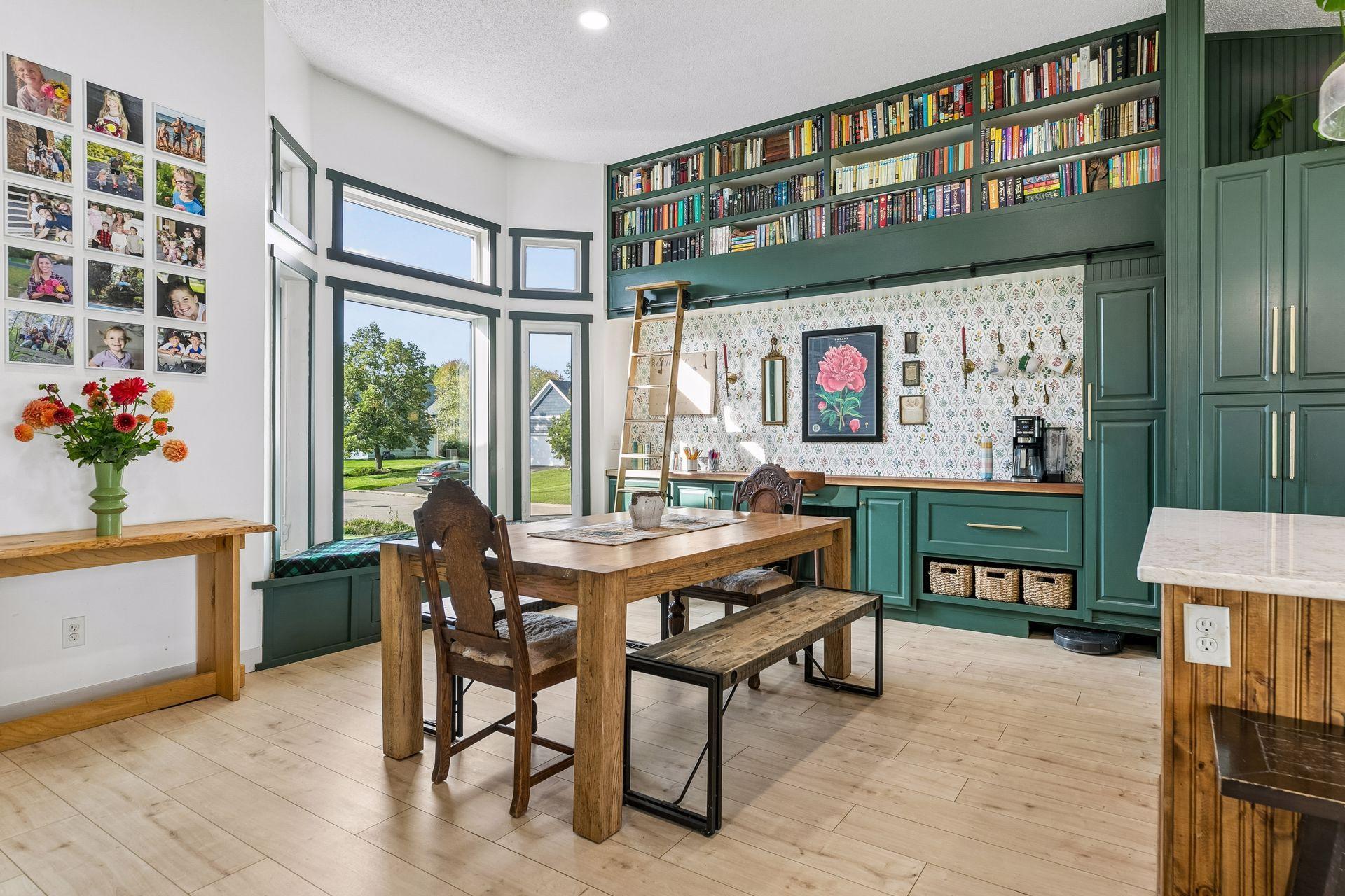 Great room includes coffee bar, computer station, library ladder and dining area.