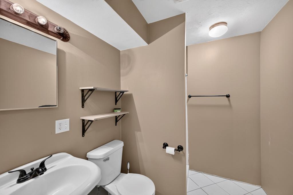 Lower level bath has a walk-in shower.