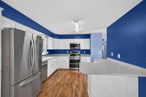 Beautiful kitchen with updated appliances and solid surface counters.