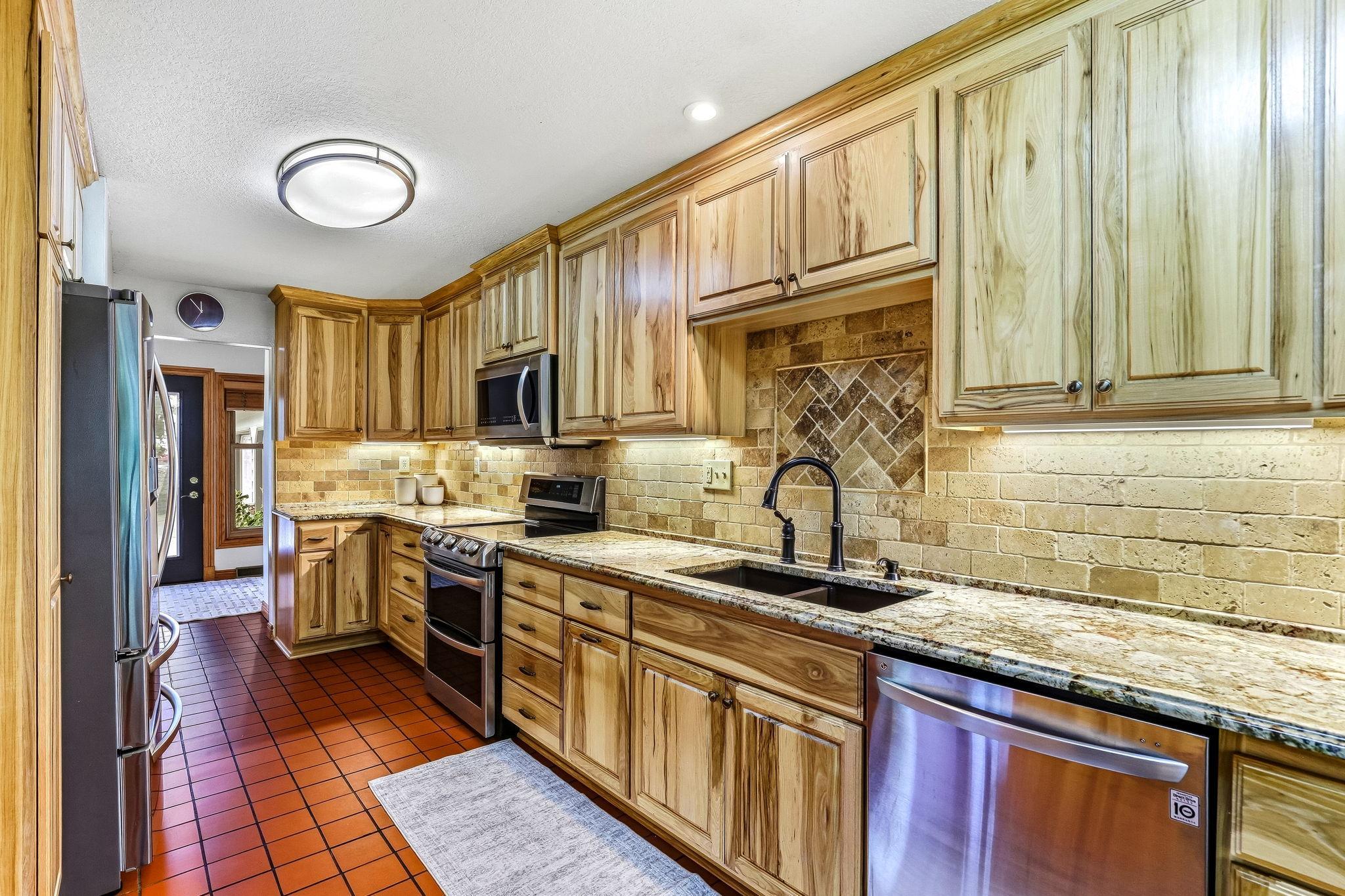 Kitchen remodeled with Hickory cabinets and Granite countertops. Appliances replaced as well.