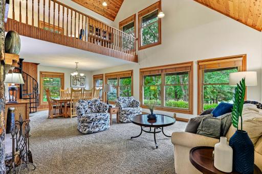 Living and dining area with fireplace and loft above.
