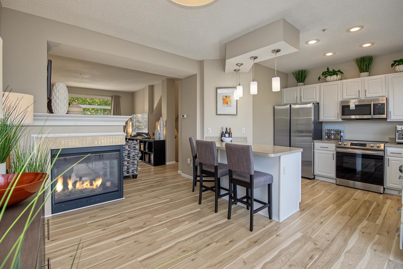Informal fireside dining area could easily accommodate a table; eat-at peninsula provides additional dining space