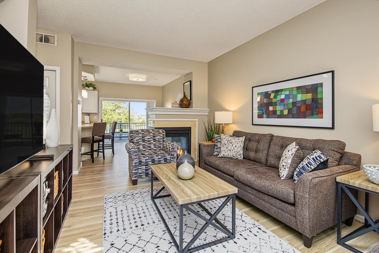 From this view you can see the great flow, three sided fireplace, the beautiful floors and the access to the deck.