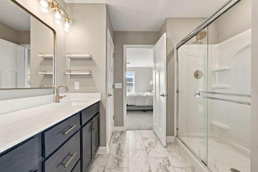 Walk-in shower, soaker tub, double vanity, and updated fixtures.