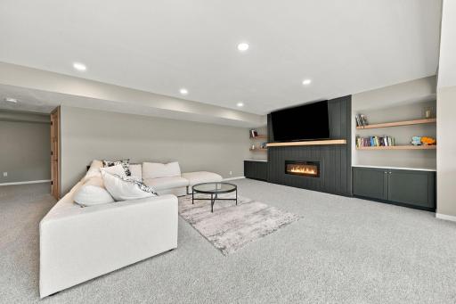 Lower level family room with stunning built in electric fireplace.