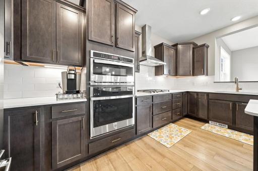 Kitchen is complete with built-in gas stove, microwave, and oven.