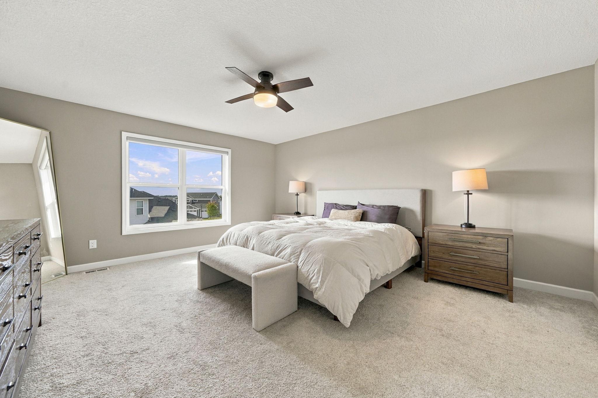 Spacious primary suite. Walk-in closet has custom shelving.