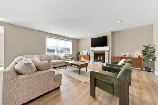 The spacious living room is complete with a gas burning stone fireplace.