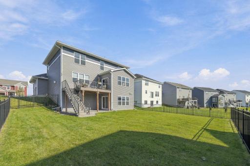 Outside is complete with a full iron fence, deck, and patio!