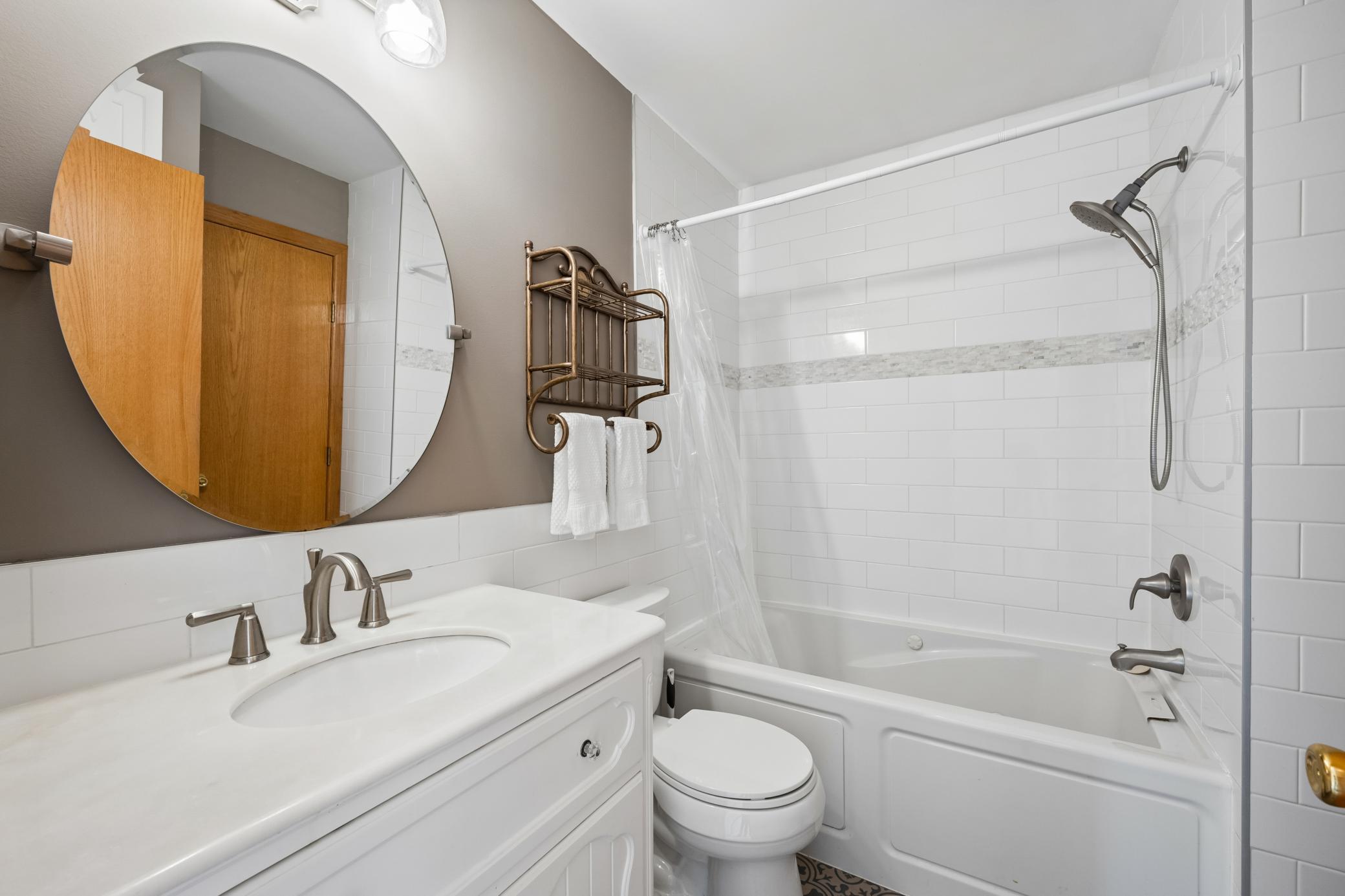 Updated bathrom wiht fresh paint, updated vanity, lighting and mirror.