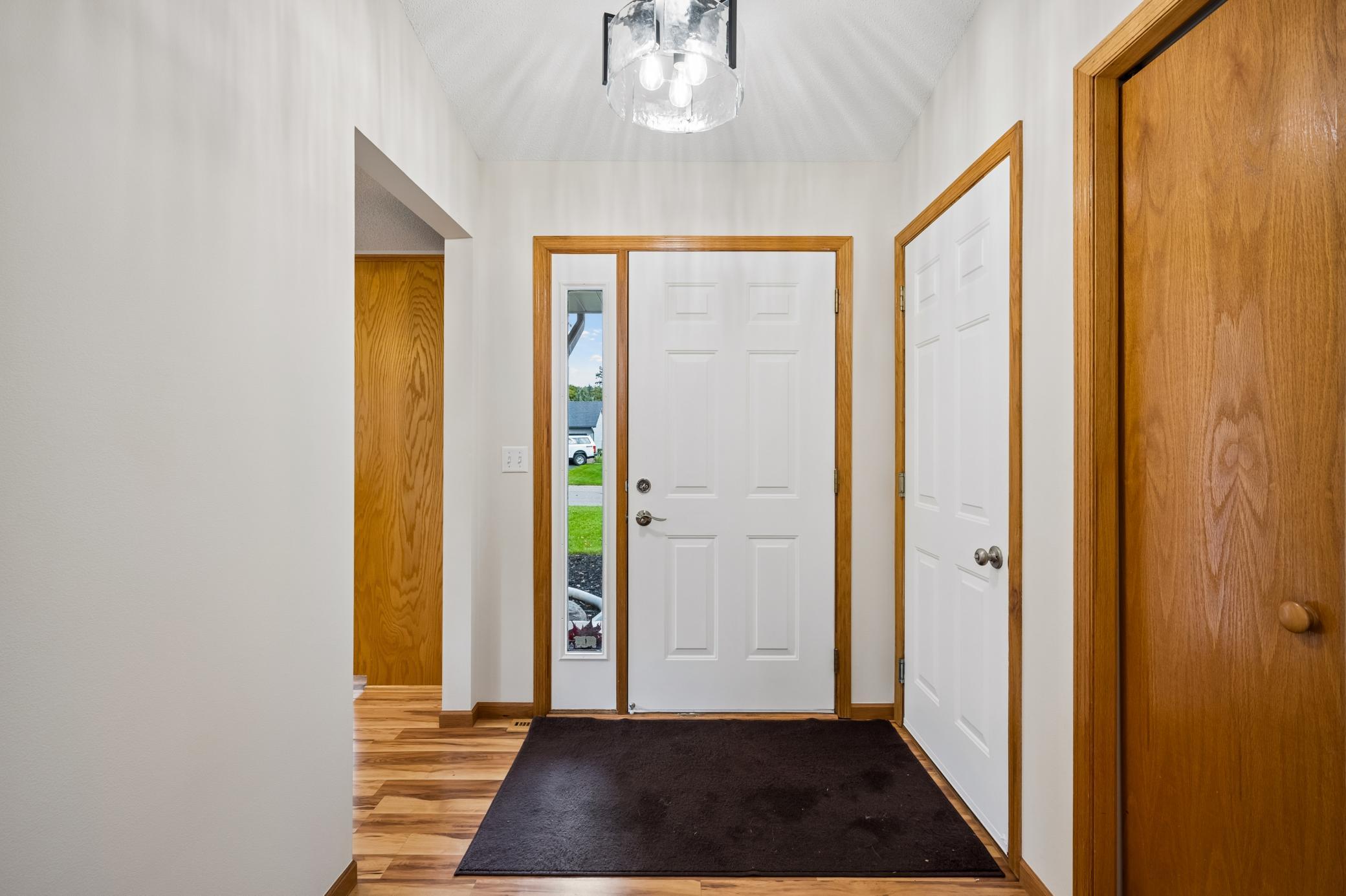 Spacious entryway with new light fixtures.