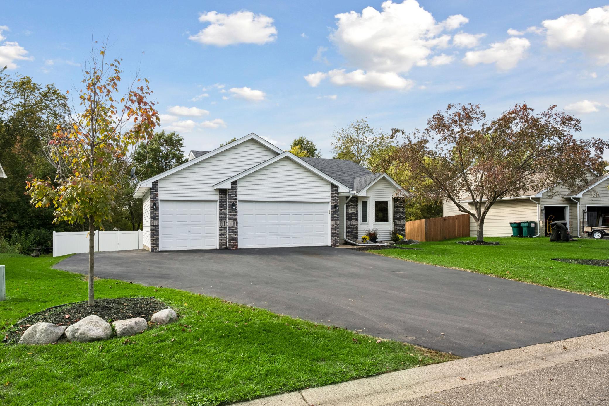Paved driveway in 2017 with an extra parking space and a 3 stall garage.