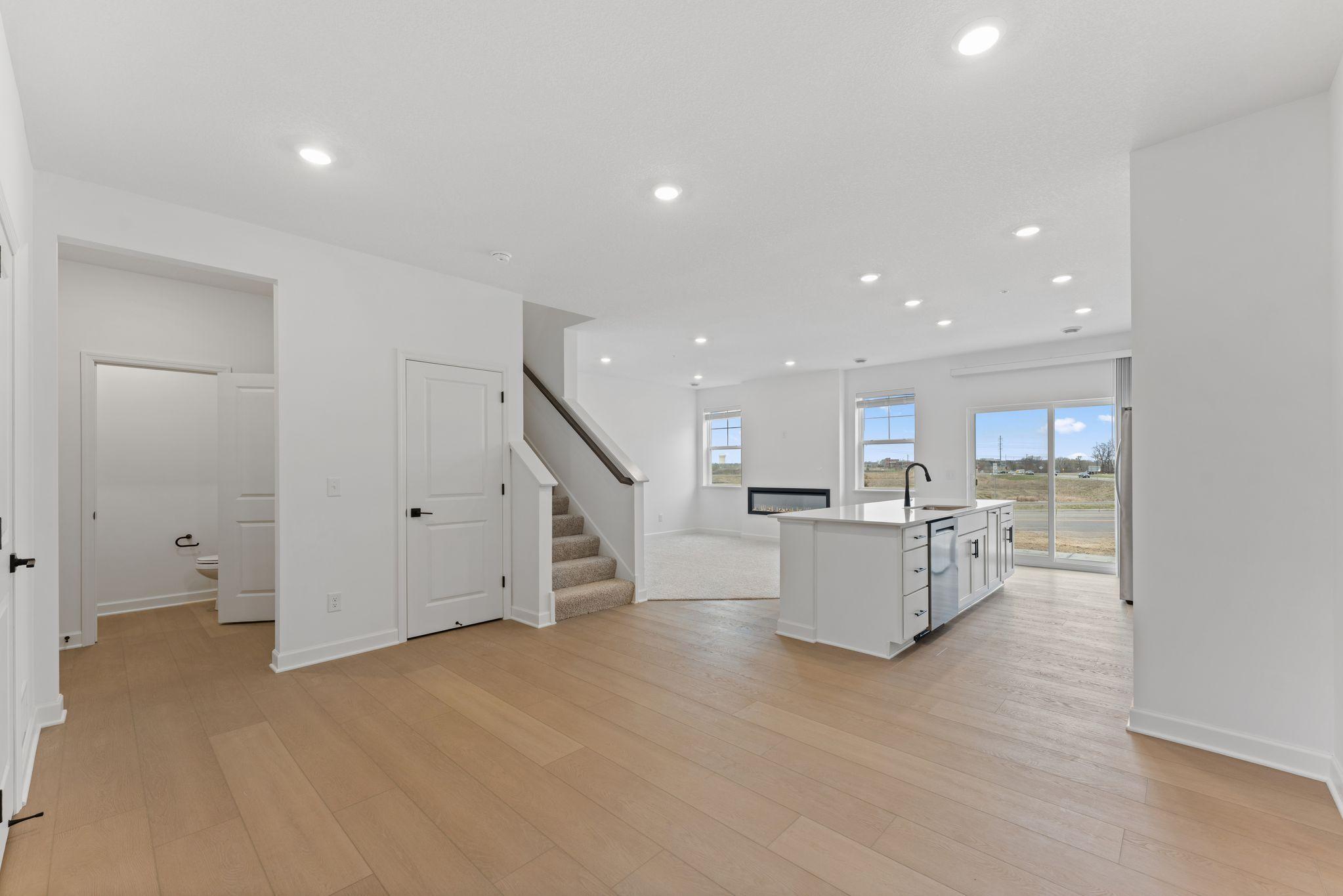 (Photo of a similar home, actual finishes may vary) Sharing space with the kitchen, the modern dining area is great for serving piping-hot meals during intimate family dinners and holiday parties.