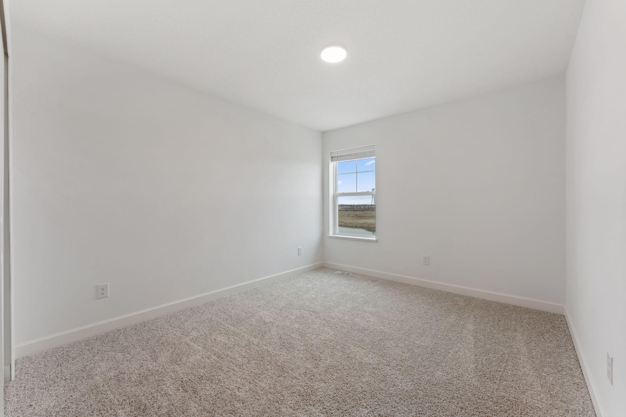 (Photo of a similar home, actual finishes may vary) The two secondary bedrooms can be found on the top level to provide a quiet haven away from the bustling downstairs main living area.