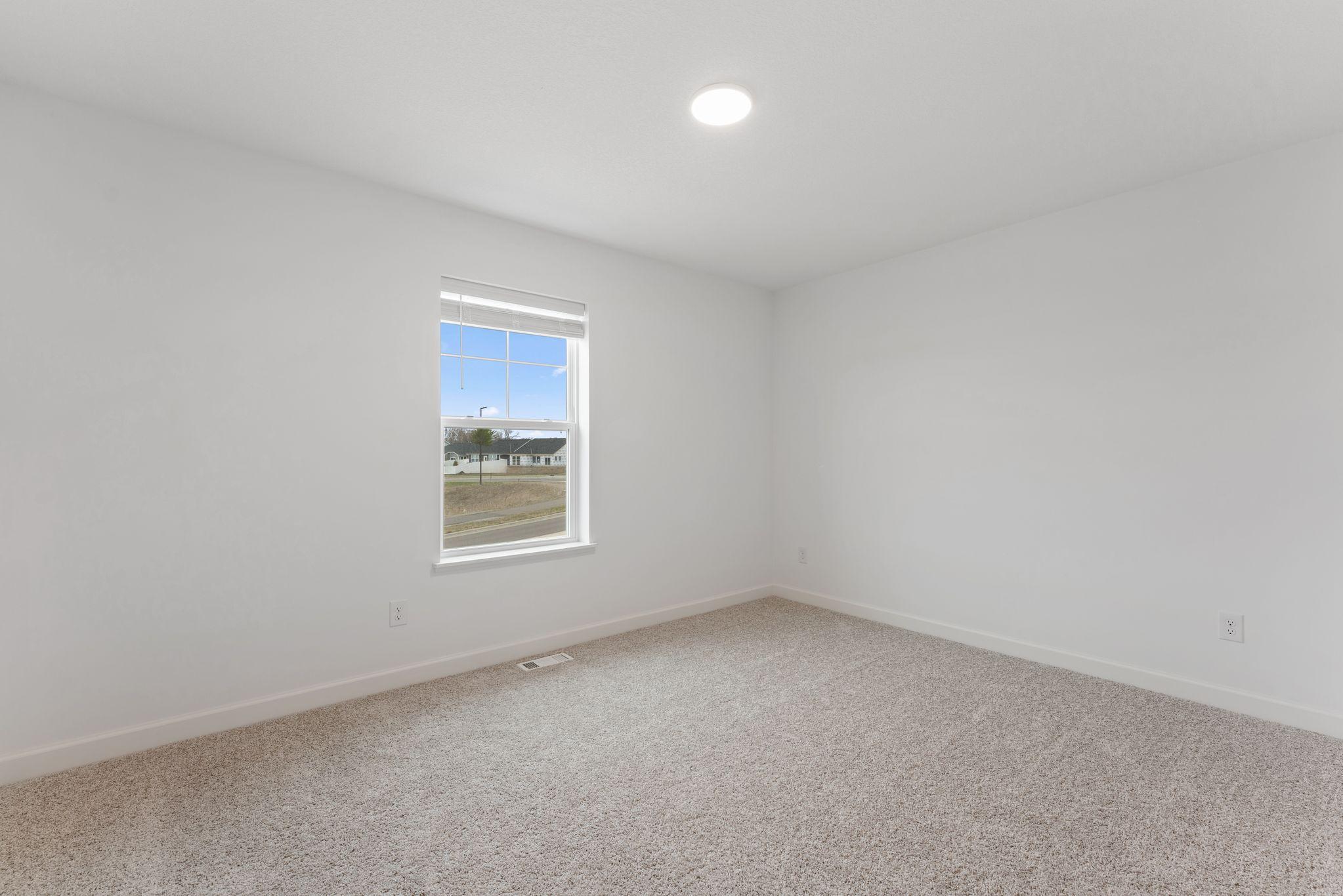 (Photo of a similar home, actual finishes may vary) All bedrooms in the home include plush wall-to-wall carpeting and practical wardrobe closets