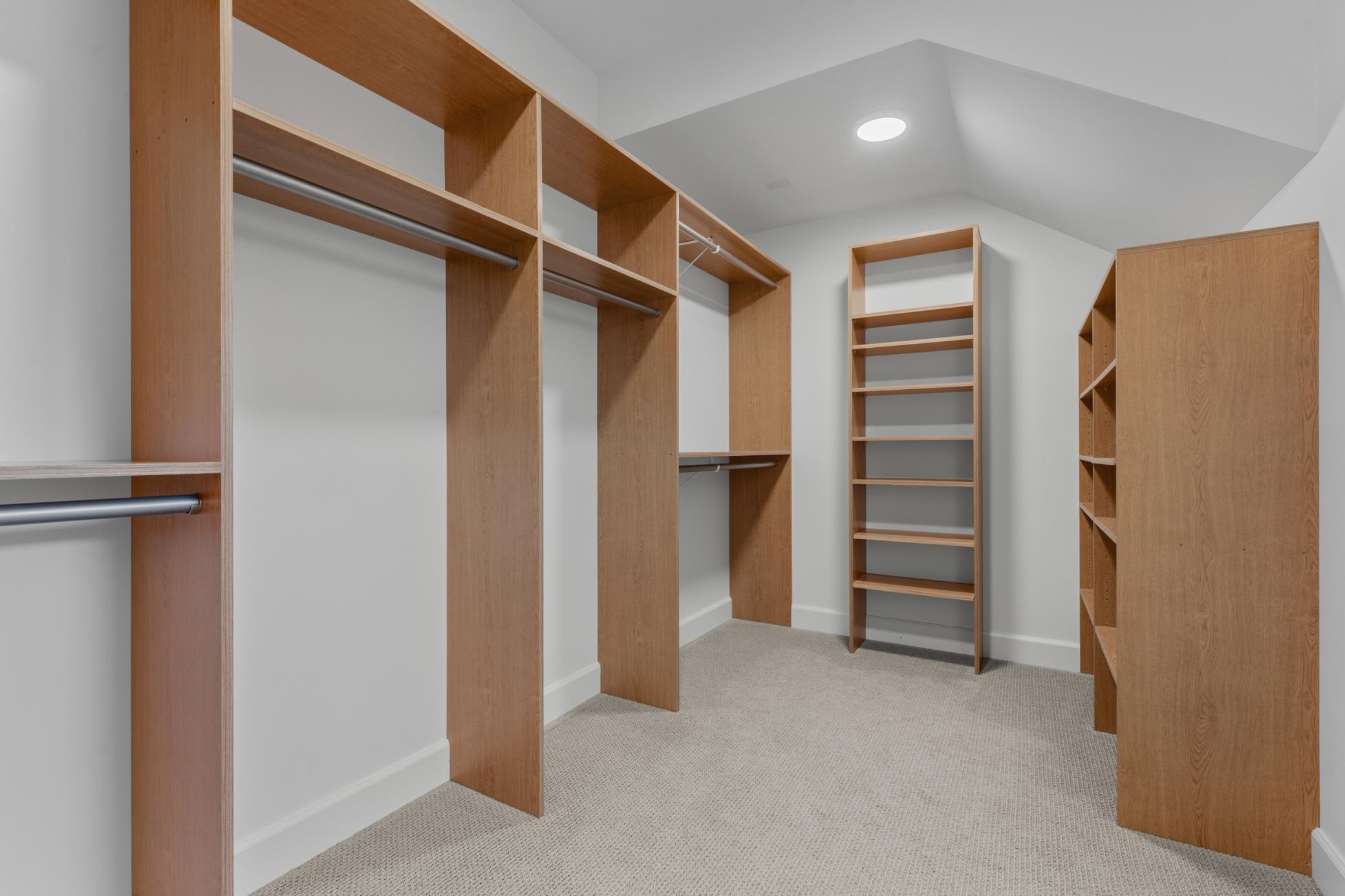 Primary Walk-In Closet with Custom Built-Ins