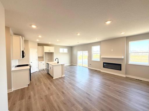 Photo From Actual Home: This plan is open concept and flows easily from kitchen to dining to living.