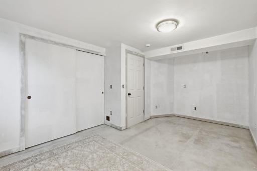 LL 4th bedroom has bright lighting and a large closet