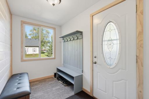 Nice Entry side porch/mudroom shows off a beautiful door.